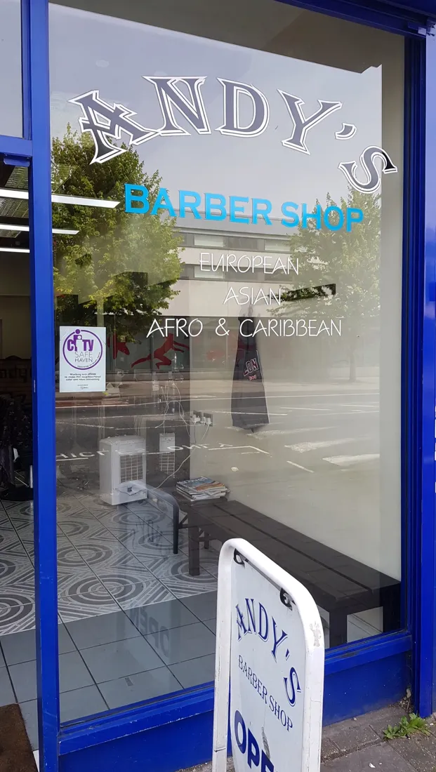 Andy's Barber Shop window with its blue frames on Bridge Road