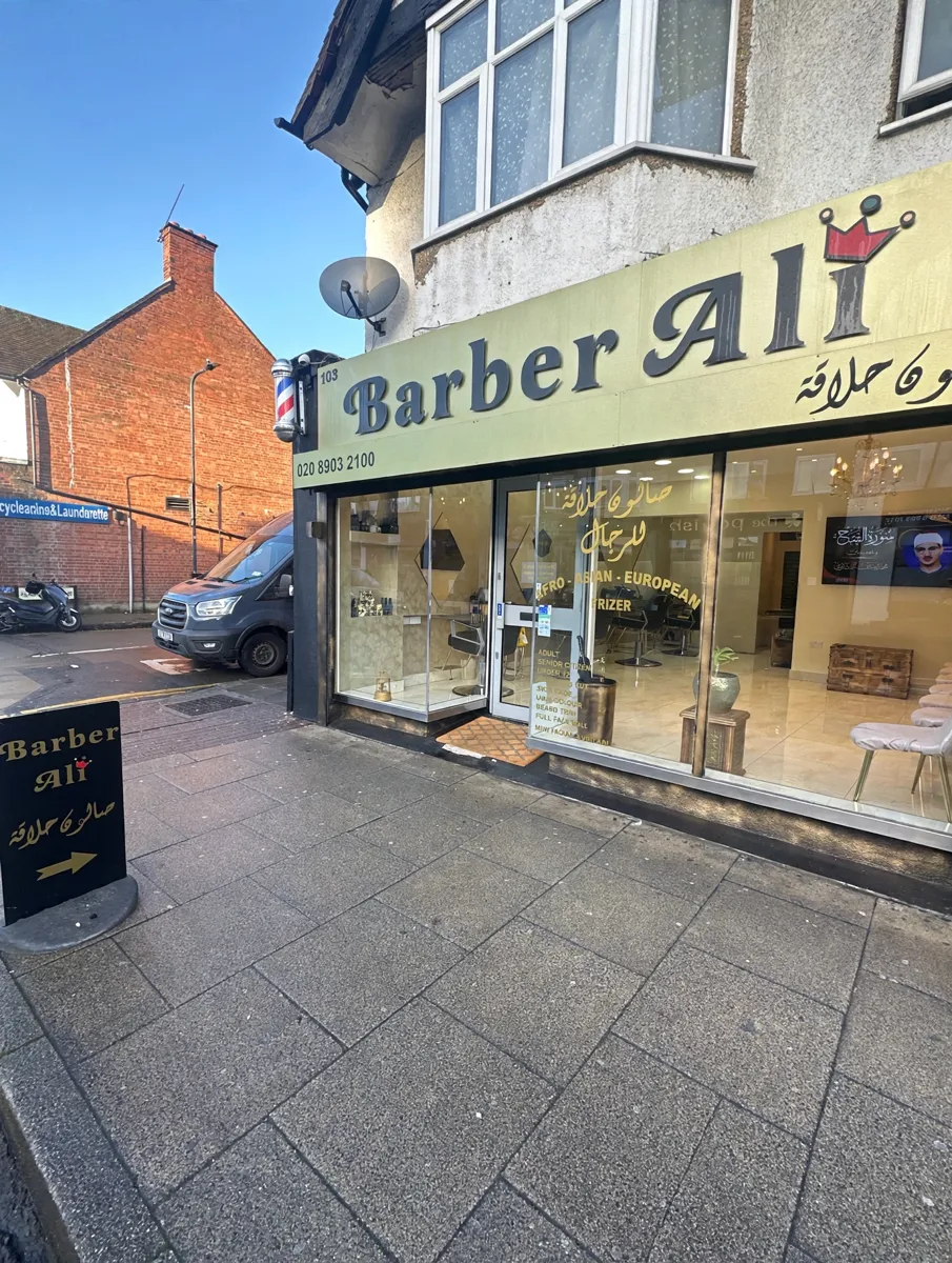 Barber Ali shopfront with its gold crown sign on Wembley Park Drive
