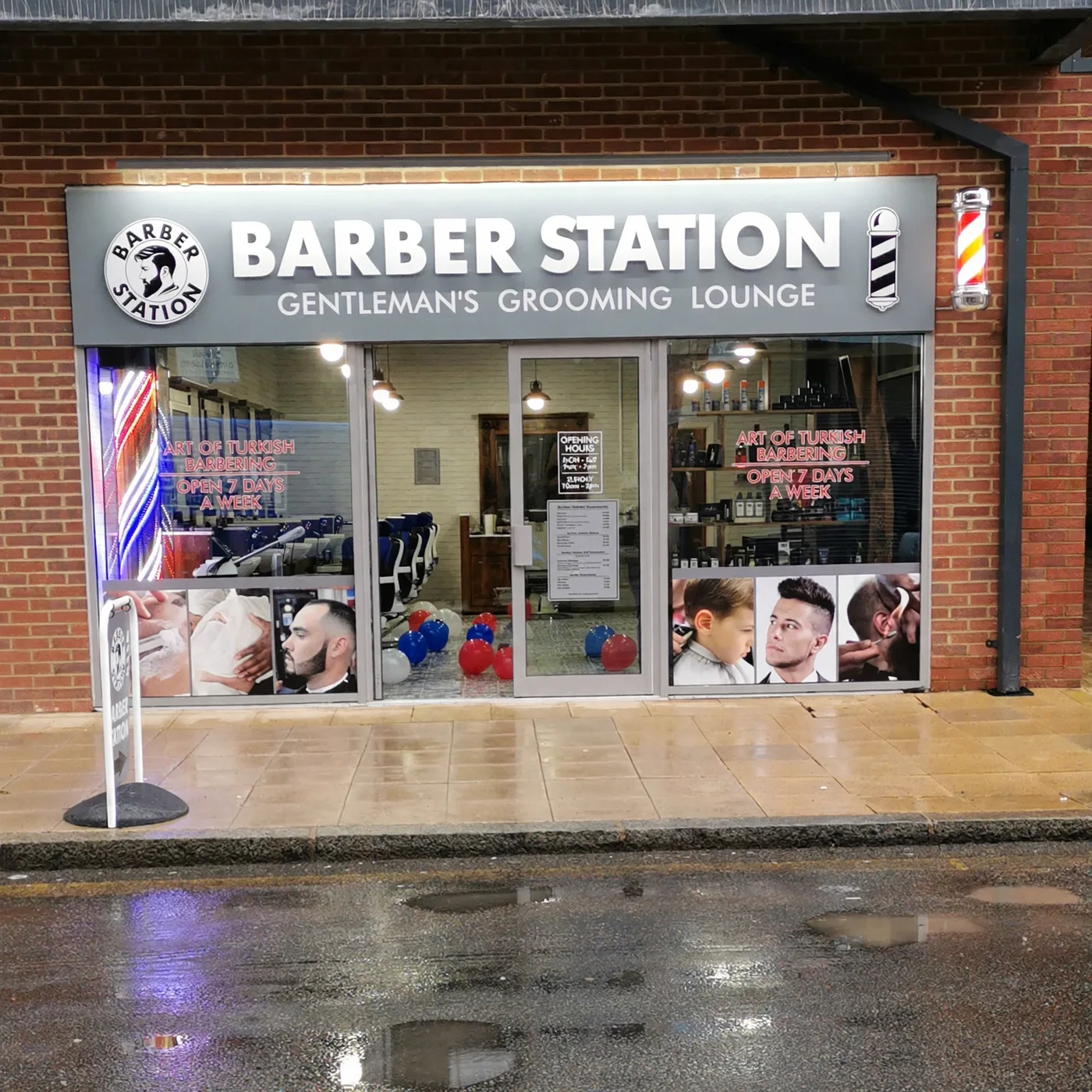 Barber Station frontage on Bakers Road: a grey 'Barber Station — Gentleman's Grooming Lounge' fascia on brick, barber poles and red 'Art of Turkish Barbering' lettering on the glass