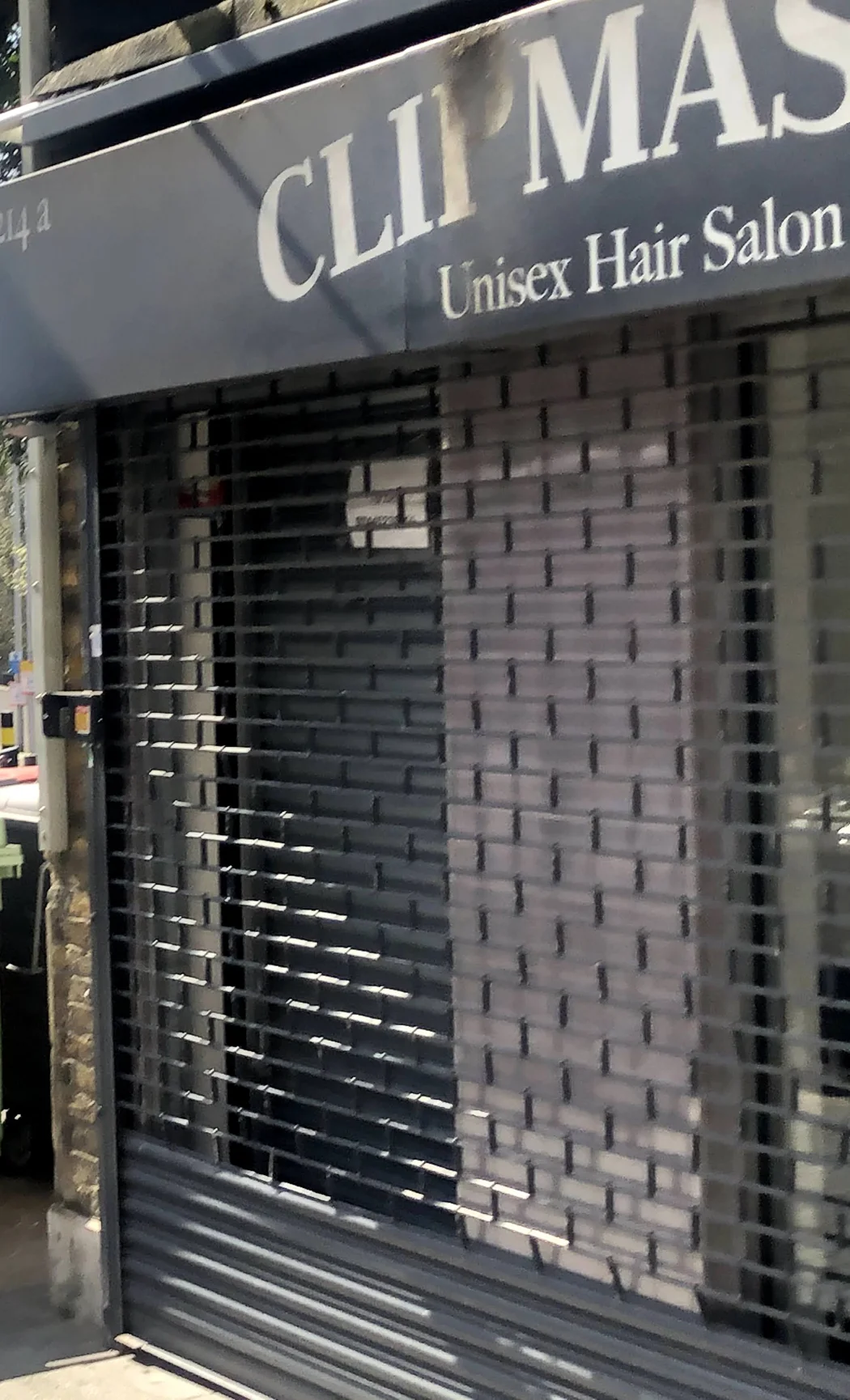 Clipmason at 214a High Street: the CLIP MAS fascia reading Unisex Hair Salon above the security grille