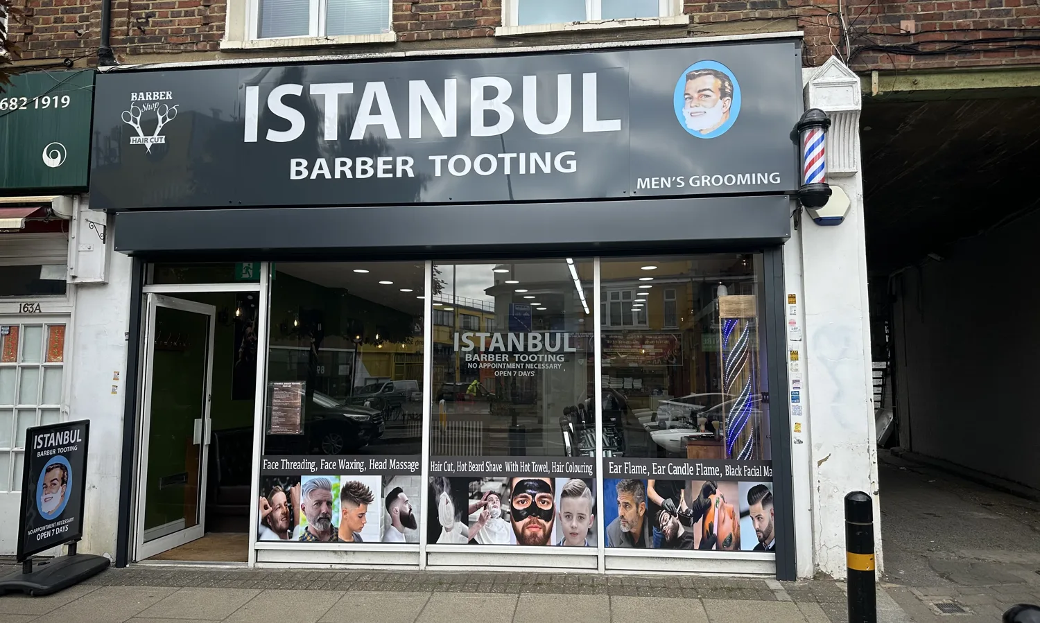 Istanbul Barber Tooting on Mitcham Road: full-width glass front with the services listed in the windows and a barber pole by the door