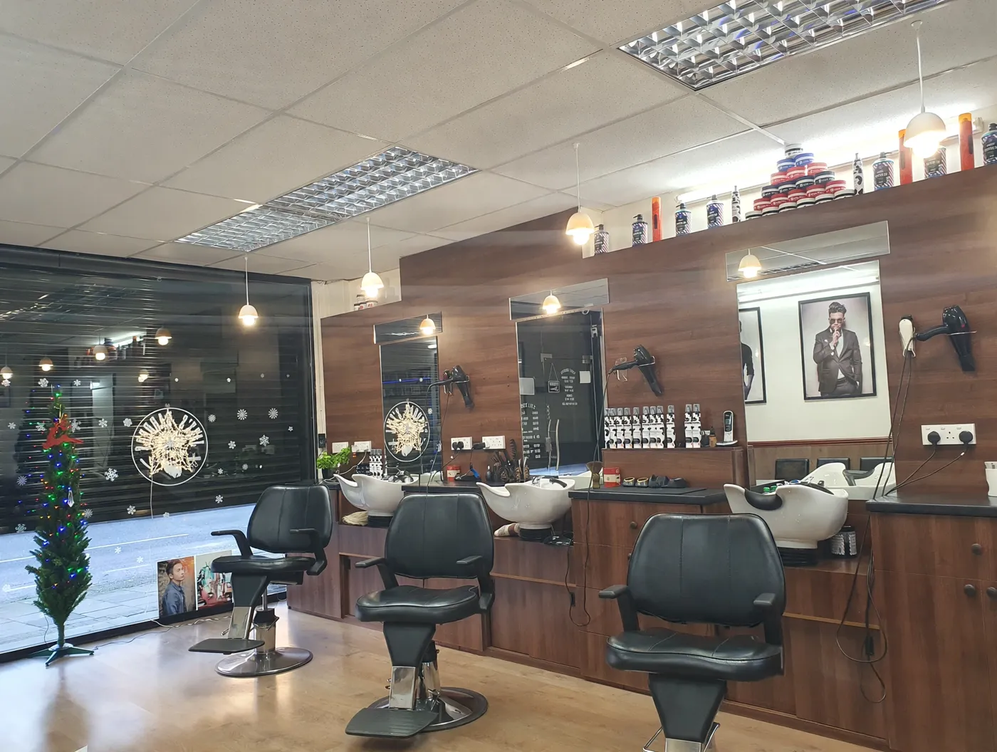 Inside Jazz's Barbers — wood-panelled walls, black chairs and backwash basins