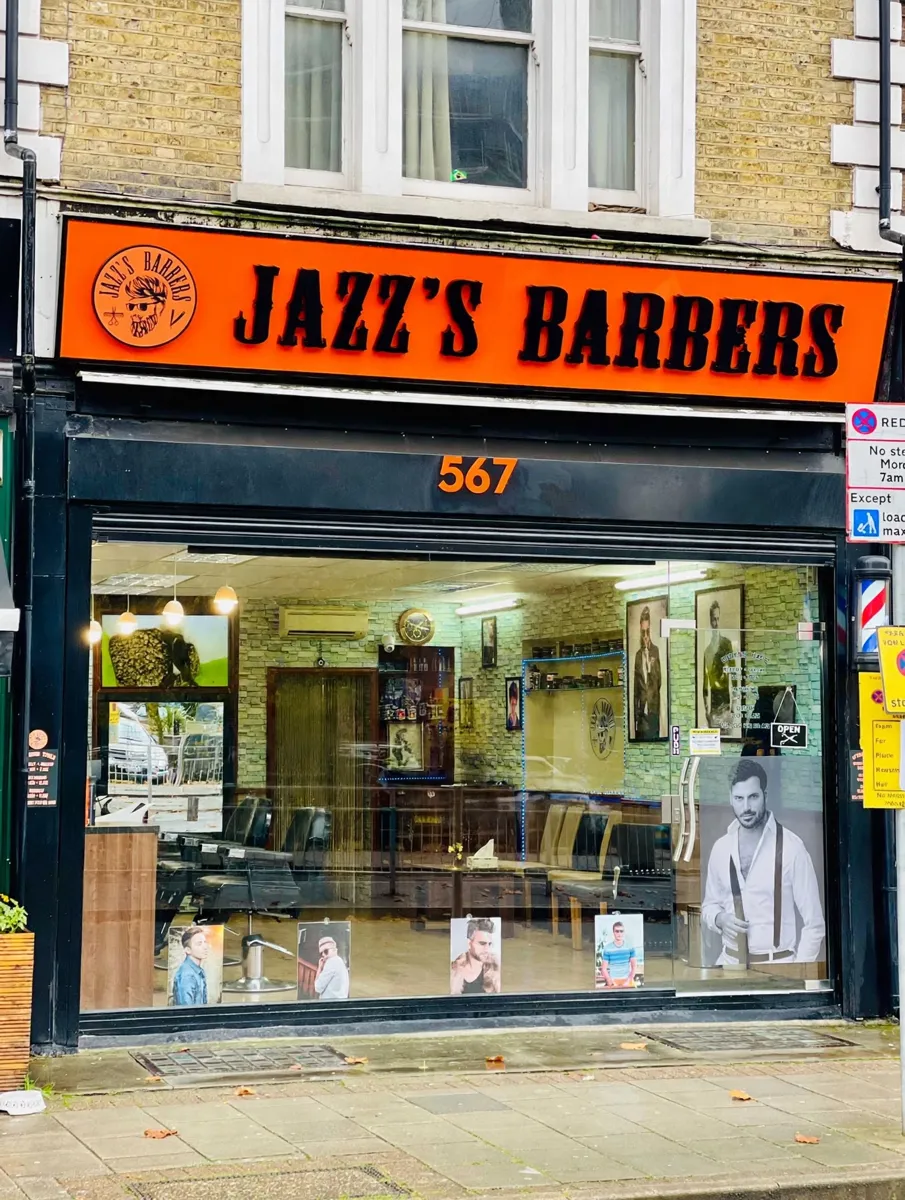 Jazz's Barbers shopfront with its big orange sign on Chiswick High Road