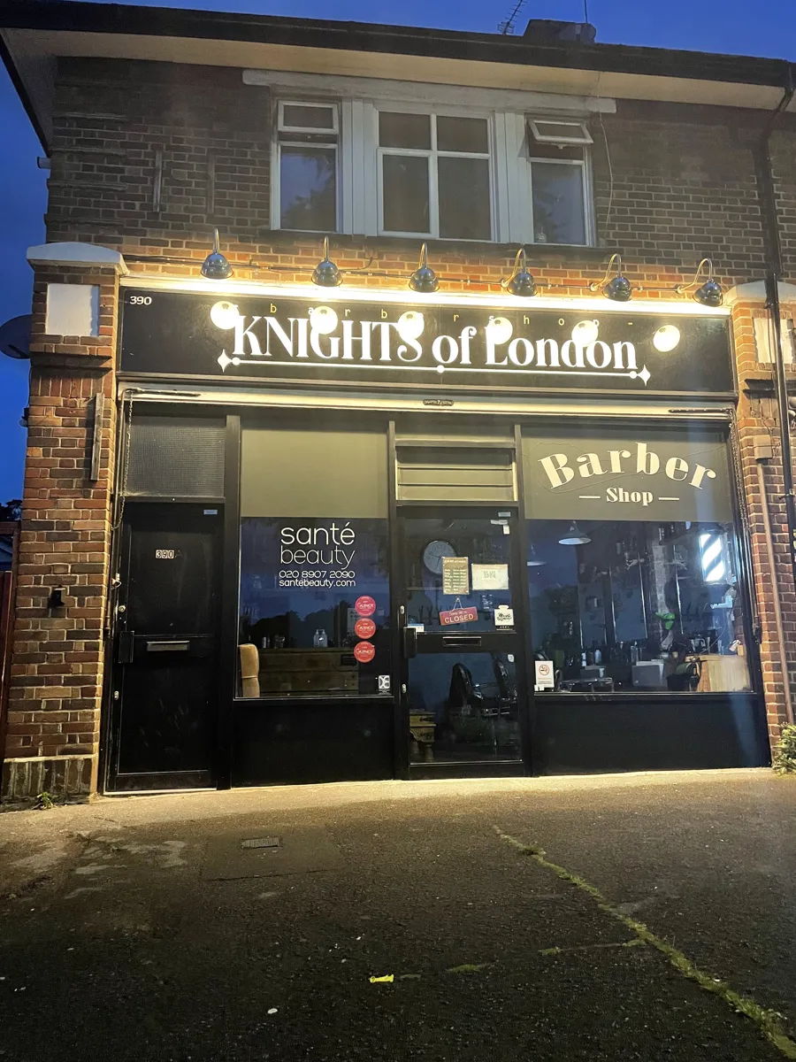 Knights of London shopfront lit up at dusk on Northolt Road