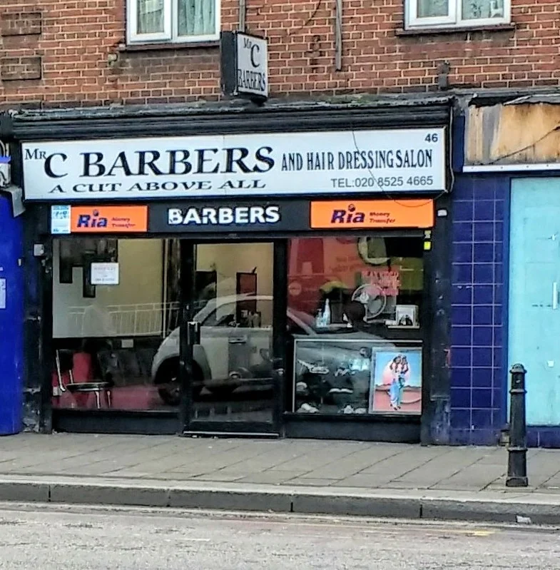 Mr C Barbers on Well Street: the white fascia reading 'Mr C Barbers and Hair Dressing Salon — a cut above all' above the glass frontage