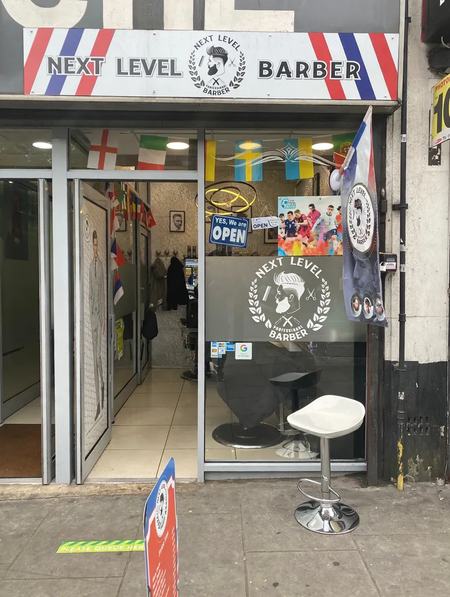 Next Level Barber shopfront with striped fascia on Greenford Broadway