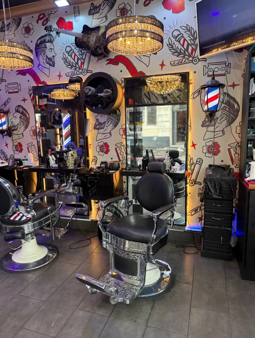 Inside Number 1 Barber — tattoo-style wallpaper, chandeliers and chrome chairs
