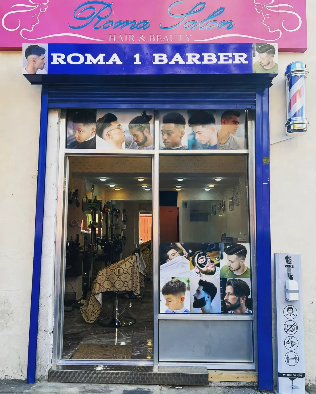 The Roma 1 Barber frontage on Boscobel Street: pink Roma Salon sign above a blue ROMA 1 BARBER fascia, barber pole and poster-covered windows