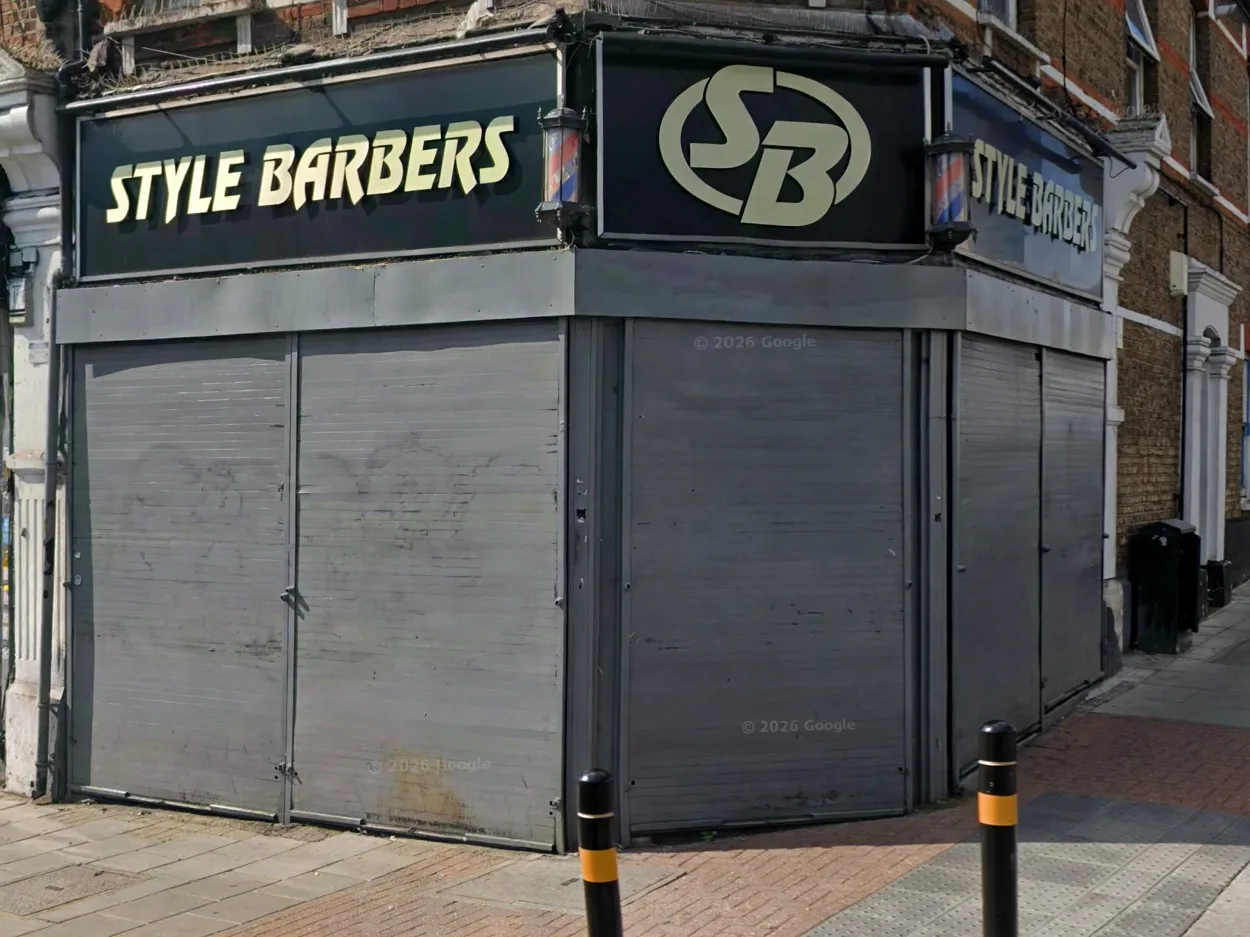 Style Barbers on the corner of Trinity Road: black fascia with gold lettering and SB monogram, barber poles and grey shutters (photographed before opening)
