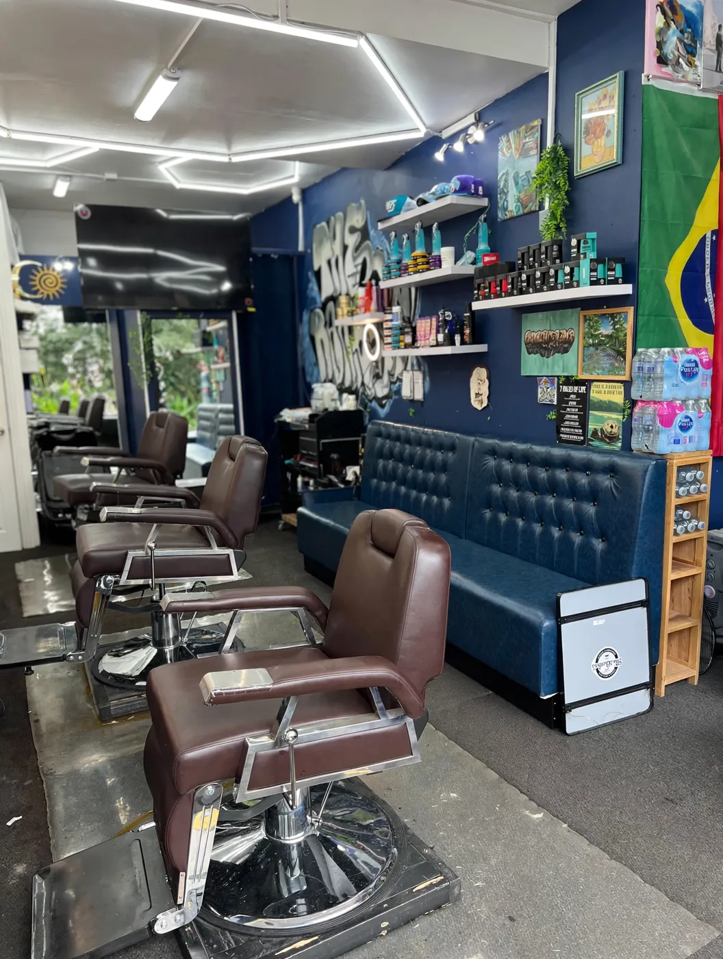 Inside The Barber's +55 — brown barber chairs, navy walls and a Brazilian flag