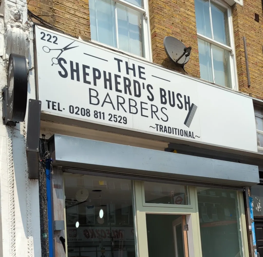 The Shepherd's Bush Barbers fascia sign and sage-green shopfront on Uxbridge Road