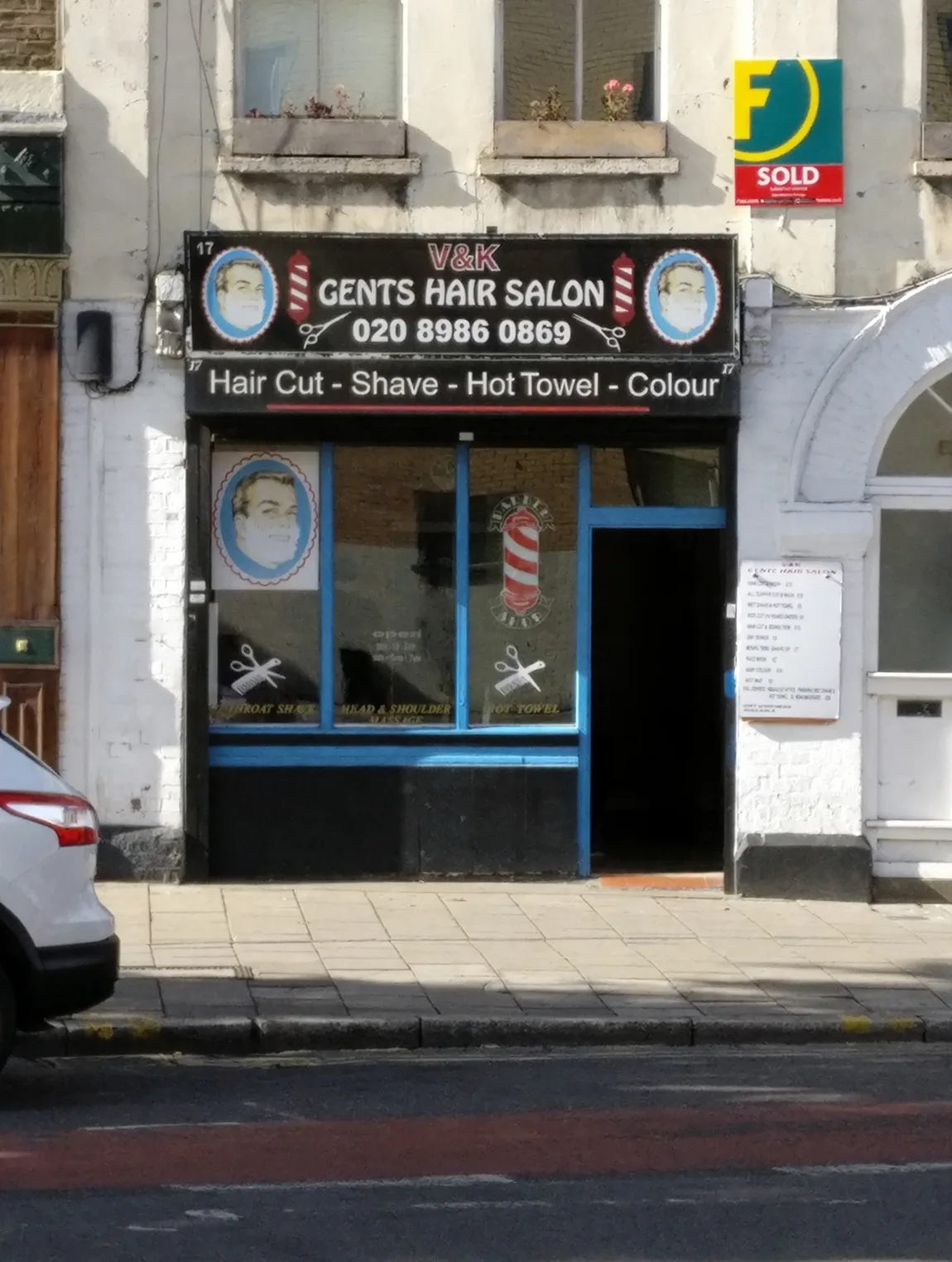 V&K Gents Hair Salon on Mare Street: black fascia with barber poles, blue window frames and the services listed underneath