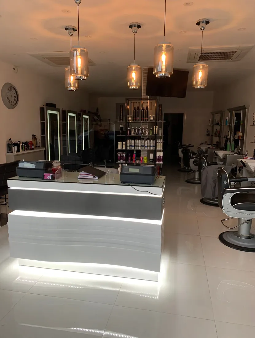Inside Vogue Ladies & City Gents — glowing reception desk and styling stations